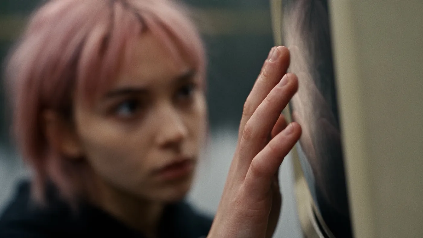 A girl reaches out to touch the glass of Screenface's monitor face