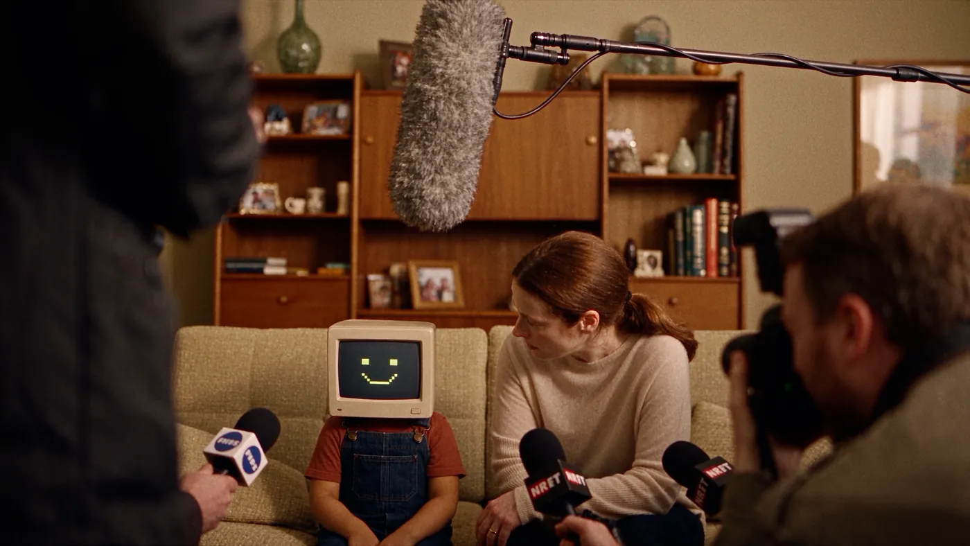The boy with a screen face on a sofa, surrounded by press microphones